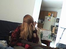 Cousin It picking It's nose... and holding a bass